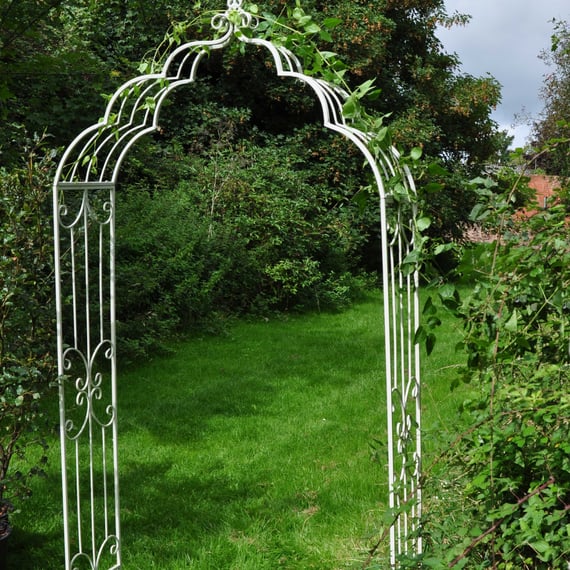 Cream Vintage Antiqued Metal Garden Arch in garden setting with climbing plants