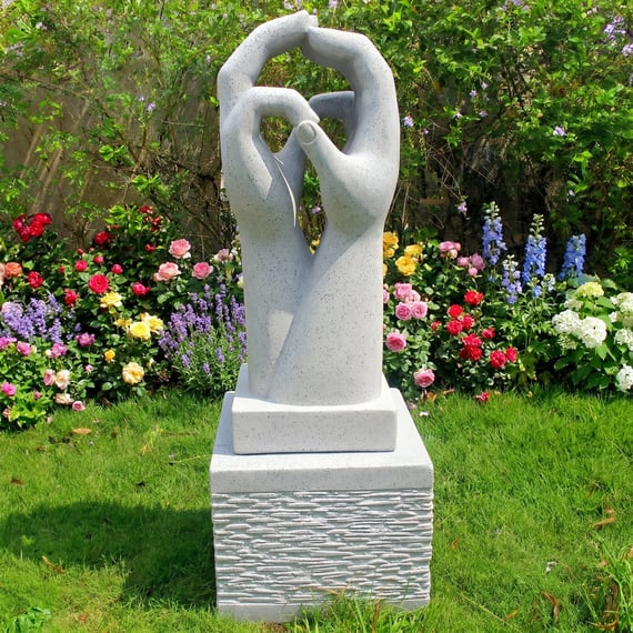 Two Hands Garden Statue in Granite in a Colourful Garden Setting