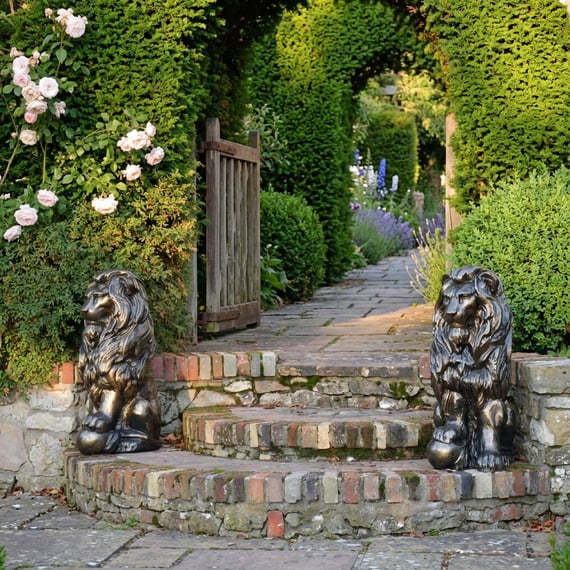 Lion With Ball Metal Garden Ornament at English country garden entrance