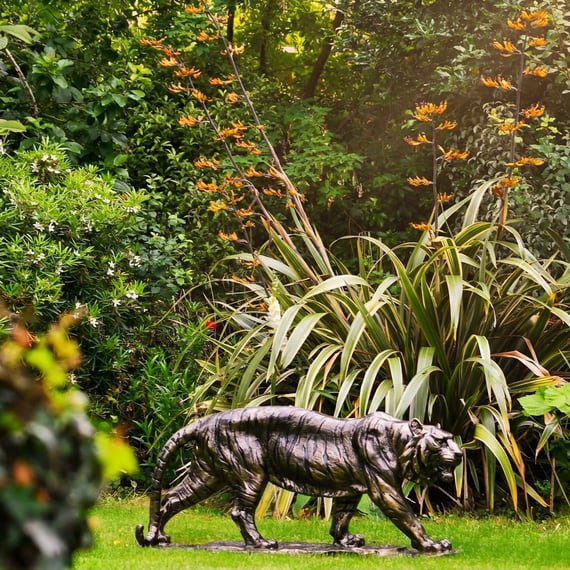 Small Tiger Metal Garden Ornament in a Lush Garden Setting