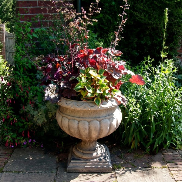 Large Buckingham cast-stone garden urn with a fluted bowl on a plinth