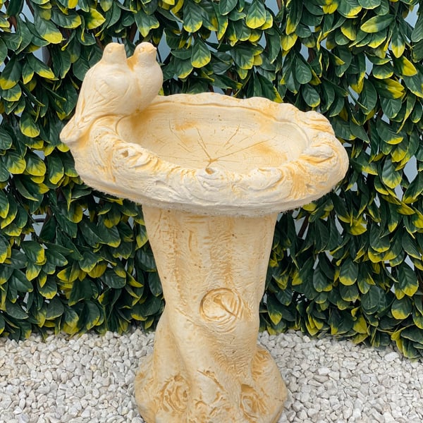 Dove Birdbath in Sand Stone with two doves on a shallow bowl and a tree-trunk pedestal