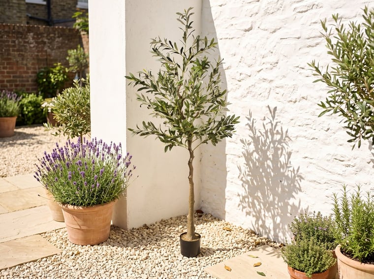 1.7m artificial olive tree on a gravel Mediterranean-style courtyard corner