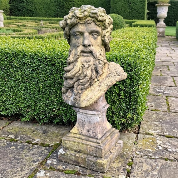 Hercules bust garden statue in weathered stone for a classical scheme