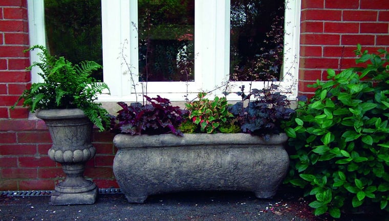 Large Catalan stone garden trough planted on a terrace
