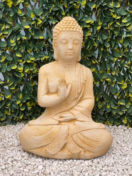 Buddha Prince sandstone statue marking a quiet zone in a UK garden